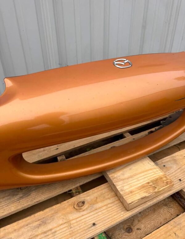 OEM factory front bumper cover for a 1999–2000 Mazda MX-5 Miata (NB generation)