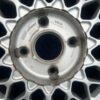 BBS RS three-piece forged split rim wheels featuring a raw silver finish, iconic cross-spoke pattern, polished stepped lips, and original black center caps with chrome BBS lettering