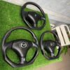 Custom Carbon Fiber Flat-Bottom Steering Wheels for Mazda Vehicles (such as the RX-7 FD and Miata NB).