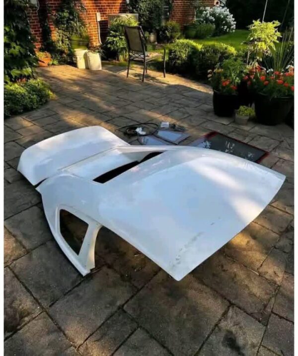 Removable fiberglass fastback roof conversion kit designed for standard convertible sports cars