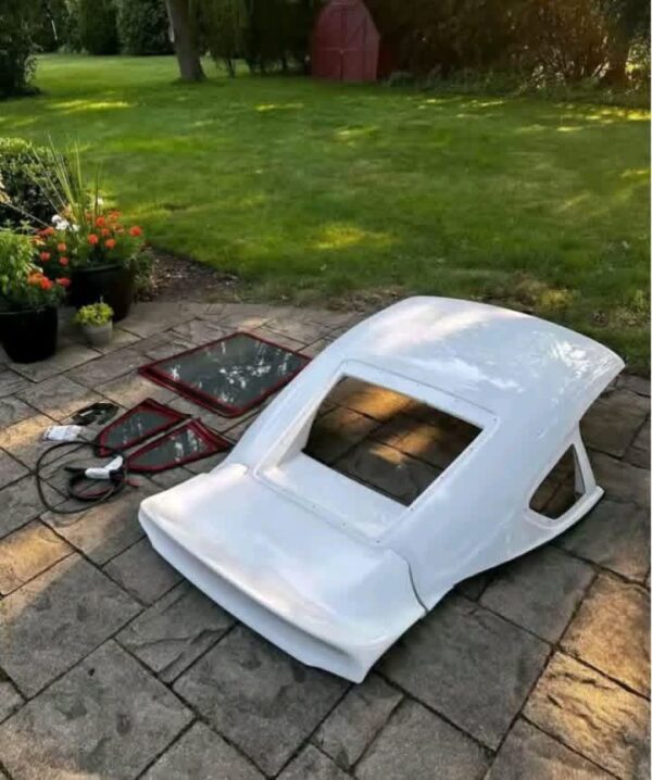 Removable fiberglass fastback roof conversion kit designed for standard convertible sports cars