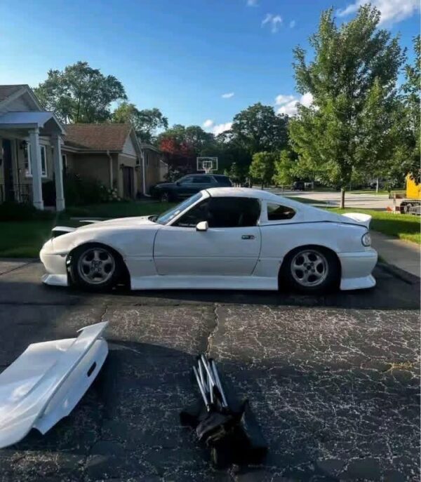 Removable fiberglass fastback roof conversion kit designed for standard convertible sports cars