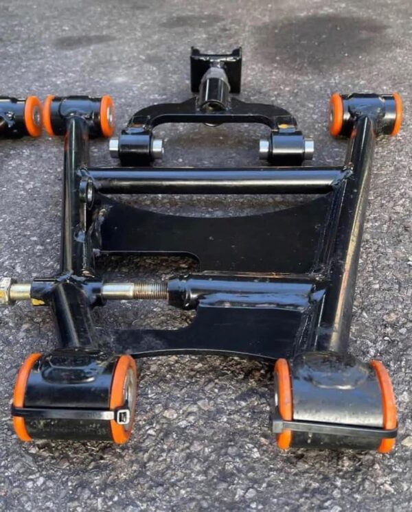 Aftermarket tubular adjustable front lower control arms featuring polyurethane bushings.