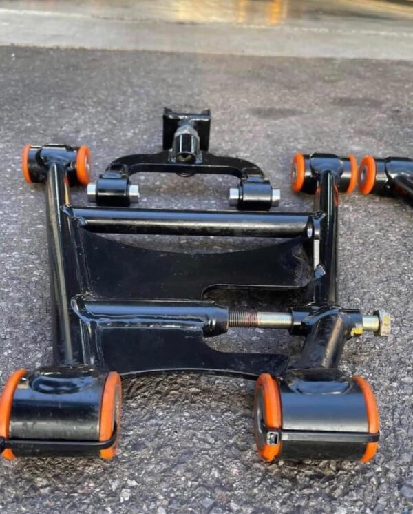 Aftermarket tubular adjustable front lower control arms featuring polyurethane bushings.