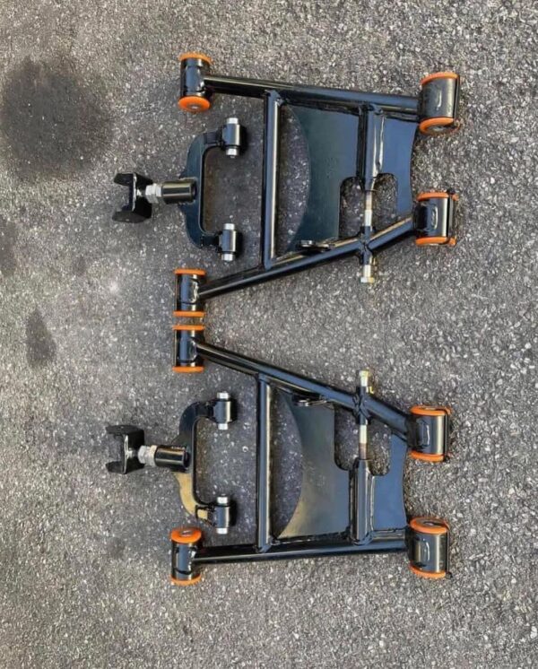 Aftermarket tubular adjustable front lower control arms featuring polyurethane bushings.