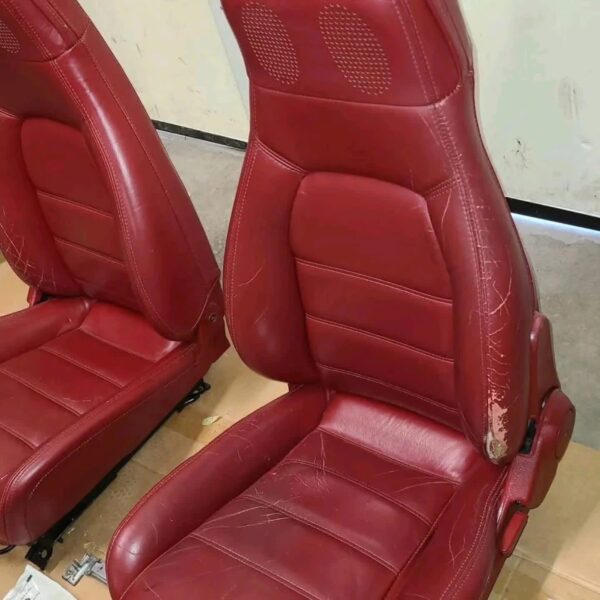 1993 Mazda MX-5 Miata Limited Edition (93LE) Red Interior Conversion Kit laid out on cardboard for a restoration or component sale