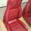 1993 Mazda MX-5 Miata Limited Edition (93LE) Red Interior Conversion Kit laid out on cardboard for a restoration or component sale