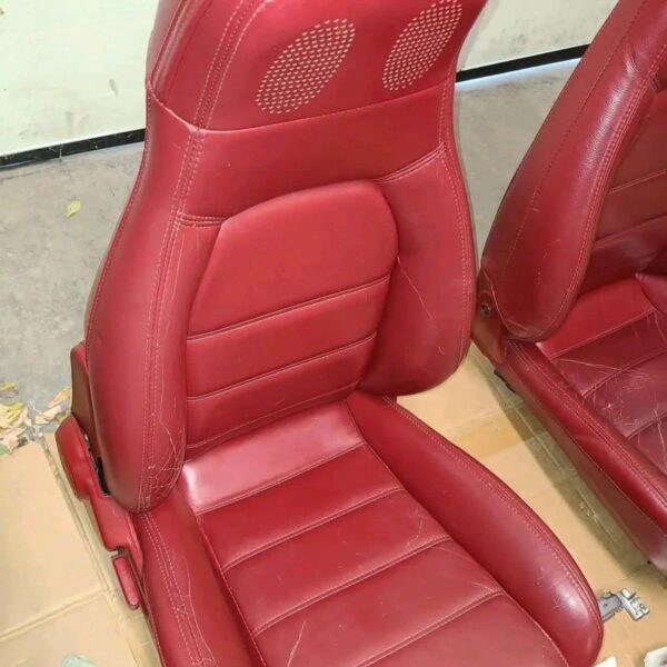 1993 Mazda MX-5 Miata Limited Edition (93LE) Red Interior Conversion Kit laid out on cardboard for a restoration or component sale
