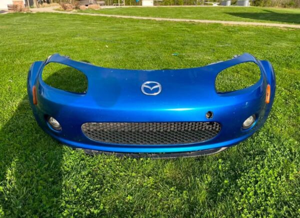 OEM Mazda MX-5 Miata (NB2 / 2001–2005) Front Bumper Cover Assembly in Laser Blue / OEM Blue, complete with fog lights, center grille mesh, emblem, and lower lip.