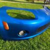 OEM Mazda MX-5 Miata (NB2 / 2001–2005) Front Bumper Cover Assembly in Laser Blue / OEM Blue, complete with fog lights, center grille mesh, emblem, and lower lip.