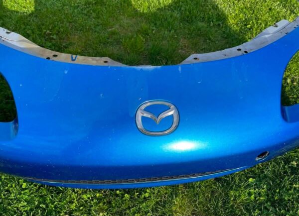 OEM Mazda MX-5 Miata (NB2 / 2001–2005) Front Bumper Cover Assembly in Laser Blue / OEM Blue, complete with fog lights, center grille mesh, emblem, and lower lip.
