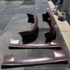 Screenshot 4-piece Full Aero Body Kit (Front Bumper, Rear Bumper, and Pair of Side Skirts) for the 1990–1997 Mazda MX-5 Miata (NA Generation), finished in dark burgundy/merlot paint.
