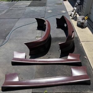 4-piece Full Aero Body Kit (Front Bumper, Rear Bumper, and Pair of Side Skirts) for the 1990–1997 Mazda MX-5 Miata (NA Generation), finished in dark burgundy/merlot paint.