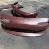 Screenshot 4-piece Full Aero Body Kit (Front Bumper, Rear Bumper, and Pair of Side Skirts) for the 1990–1997 Mazda MX-5 Miata (NA Generation), finished in dark burgundy/merlot paint.