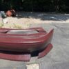 Screenshot 4-piece Full Aero Body Kit (Front Bumper, Rear Bumper, and Pair of Side Skirts) for the 1990–1997 Mazda MX-5 Miata (NA Generation), finished in dark burgundy/merlot paint.