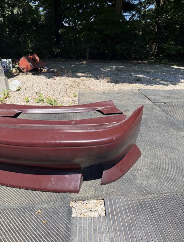 Screenshot 4-piece Full Aero Body Kit (Front Bumper, Rear Bumper, and Pair of Side Skirts) for the 1990–1997 Mazda MX-5 Miata (NA Generation), finished in dark burgundy/merlot paint.