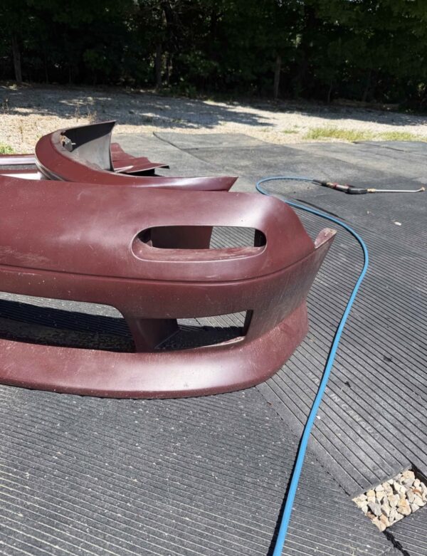 Screenshot 4-piece Full Aero Body Kit (Front Bumper, Rear Bumper, and Pair of Side Skirts) for the 1990–1997 Mazda MX-5 Miata (NA Generation), finished in dark burgundy/merlot paint.