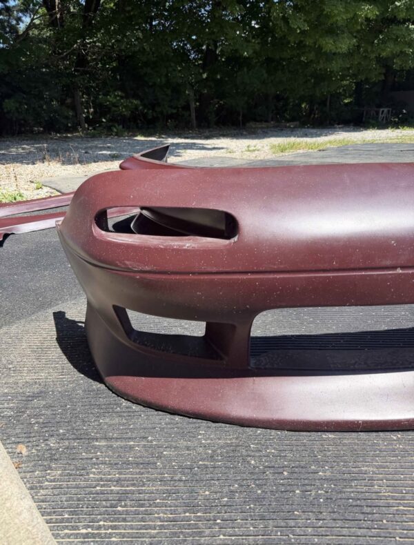 Screenshot 4-piece Full Aero Body Kit (Front Bumper, Rear Bumper, and Pair of Side Skirts) for the 1990–1997 Mazda MX-5 Miata (NA Generation), finished in dark burgundy/merlot paint.