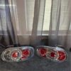 Pair of OEM Mazda MX-5 Miata (NB generation, specifically NB2 / 2001–2005) Clear Tail Lights / Taillights (often referred to as Altezza-style or factory clear-lens rear combination lamps).