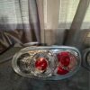 Pair of OEM Mazda MX-5 Miata (NB generation, specifically NB2 / 2001–2005) Clear Tail Lights / Taillights (often referred to as Altezza-style or factory clear-lens rear combination lamps).